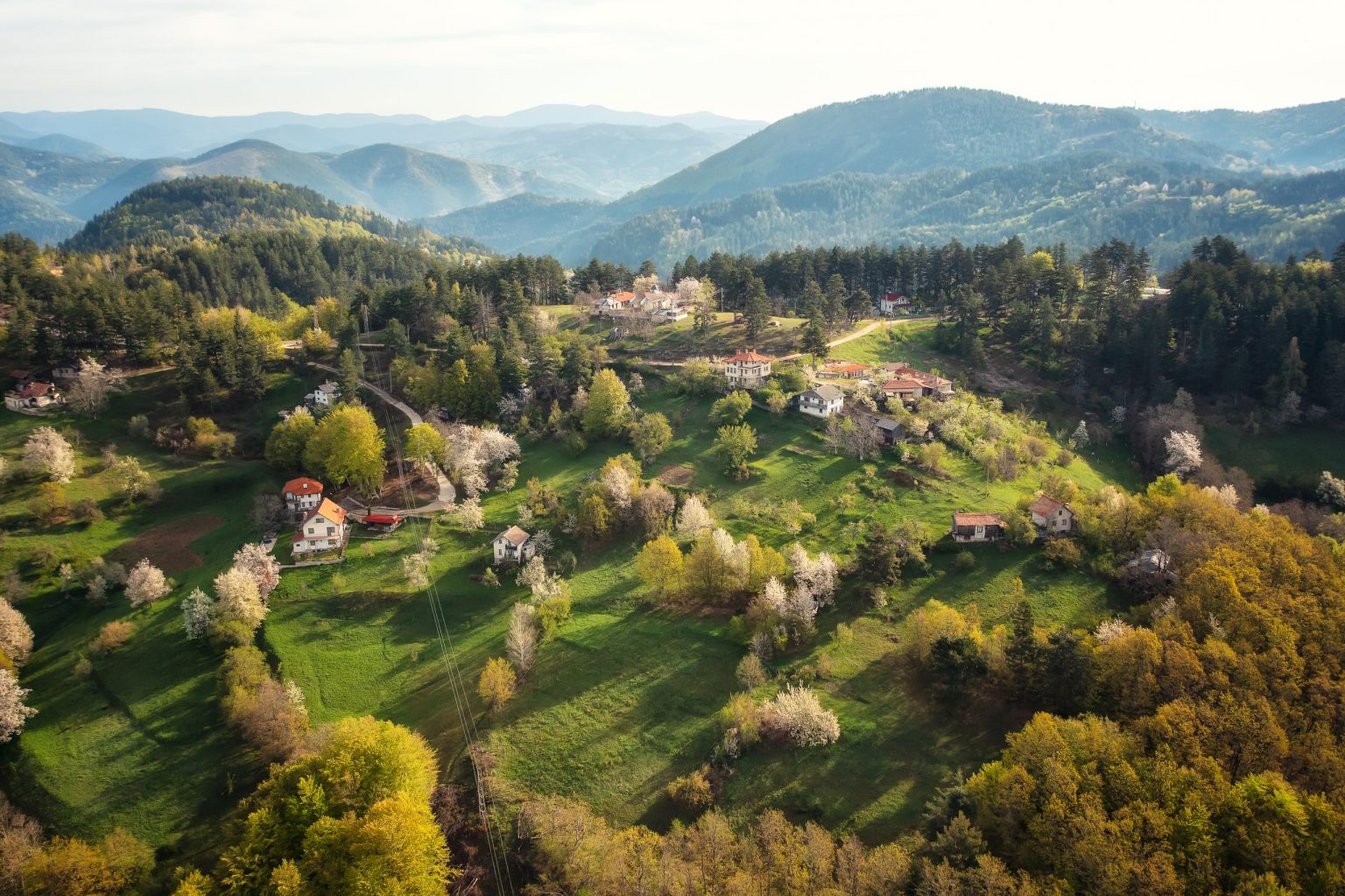 Village among green hills and blossoming orchards in the Bulgarian mountains