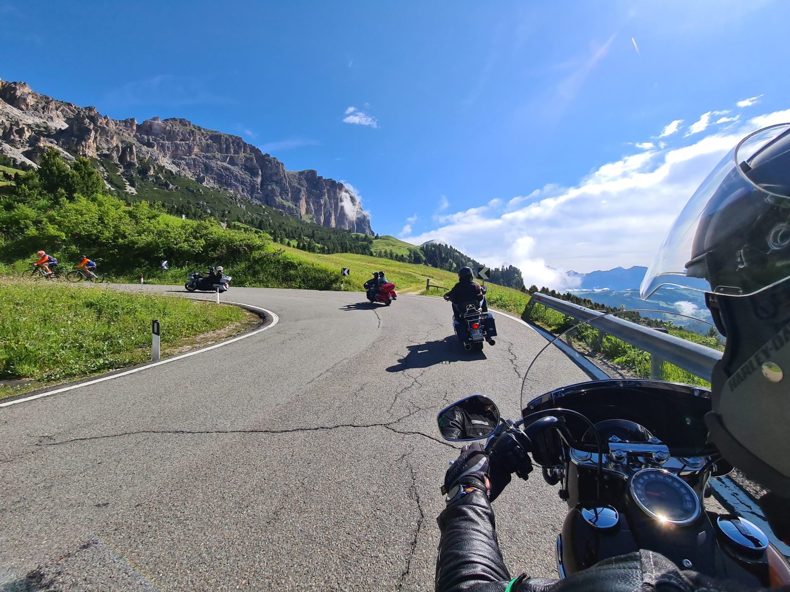 Rider's view of motorcyclists on a Dolomites pass road