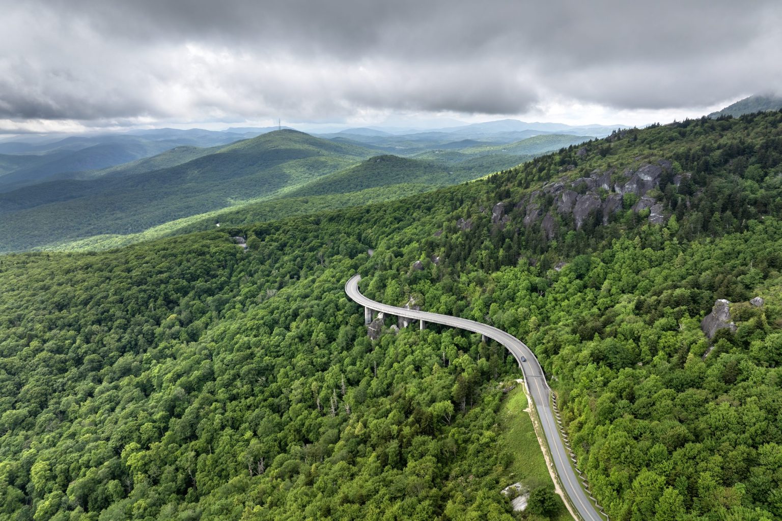 Aerial view of the Blue Ridge Parkway curving across forested mountainside