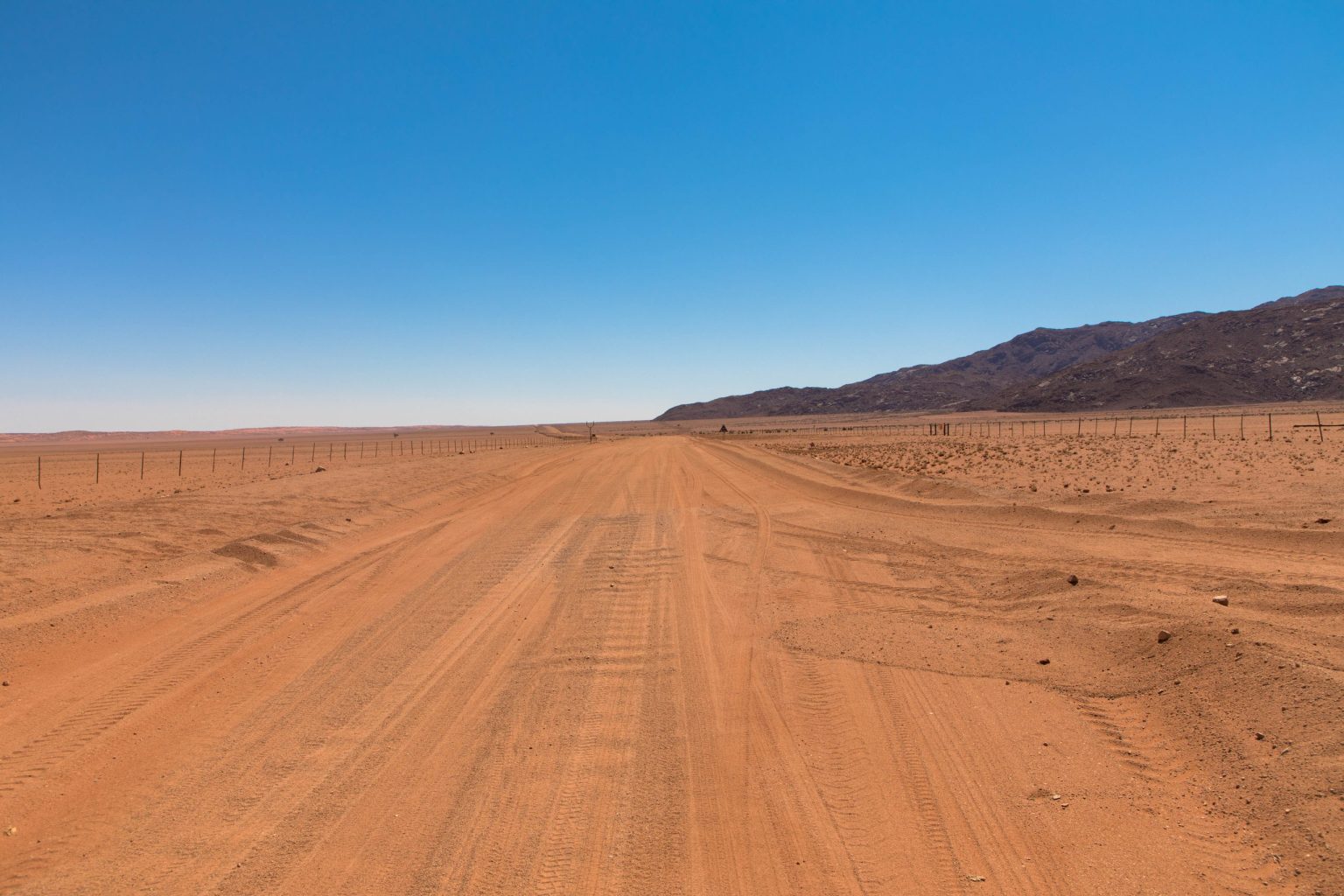 Straight gravel road towards the Tiras Mountains, Namibia