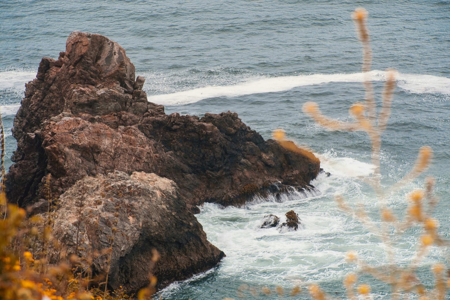 Rocky sea stack and crashing surf on the Northern California coast