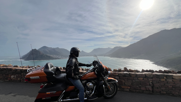 Rider on a Harley-Davidson at a viewpoint over Hout Bay