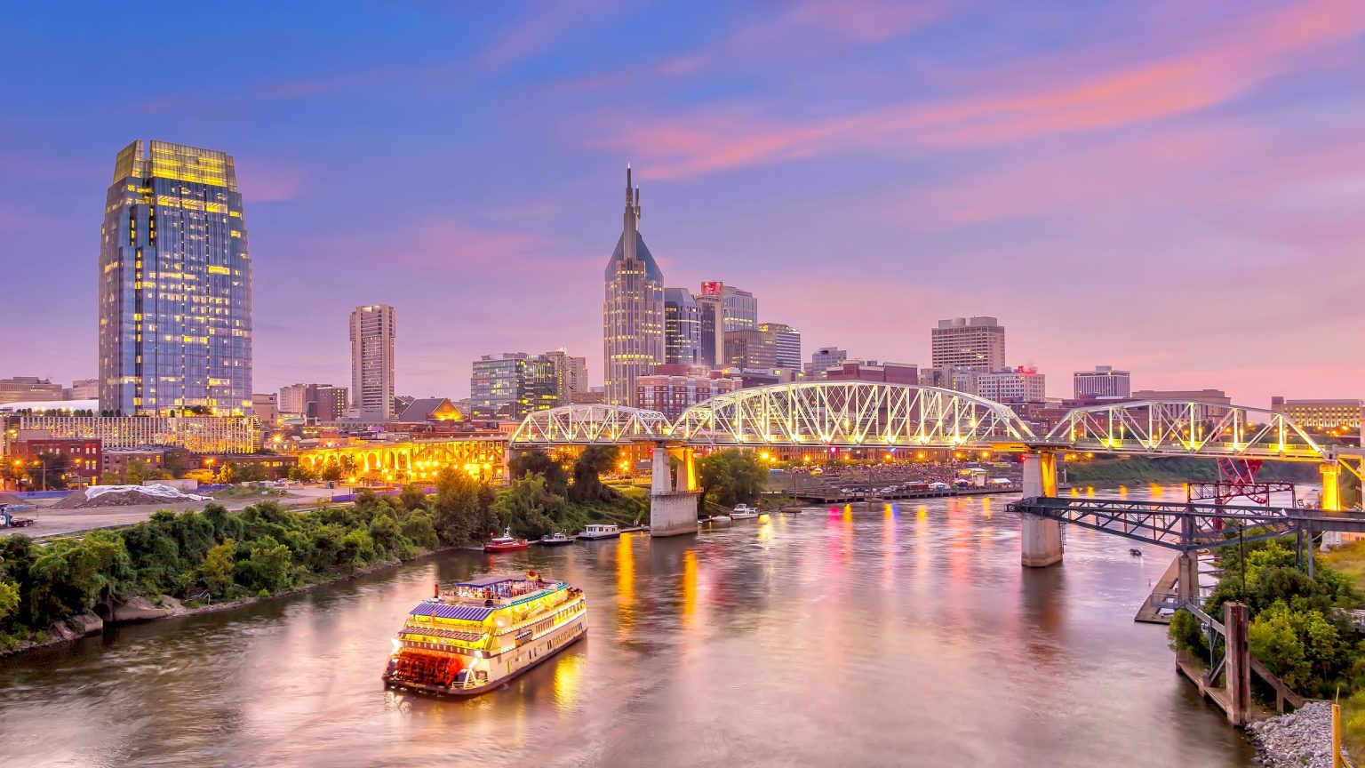 Nashville skyline and a riverboat on the Cumberland River at dusk