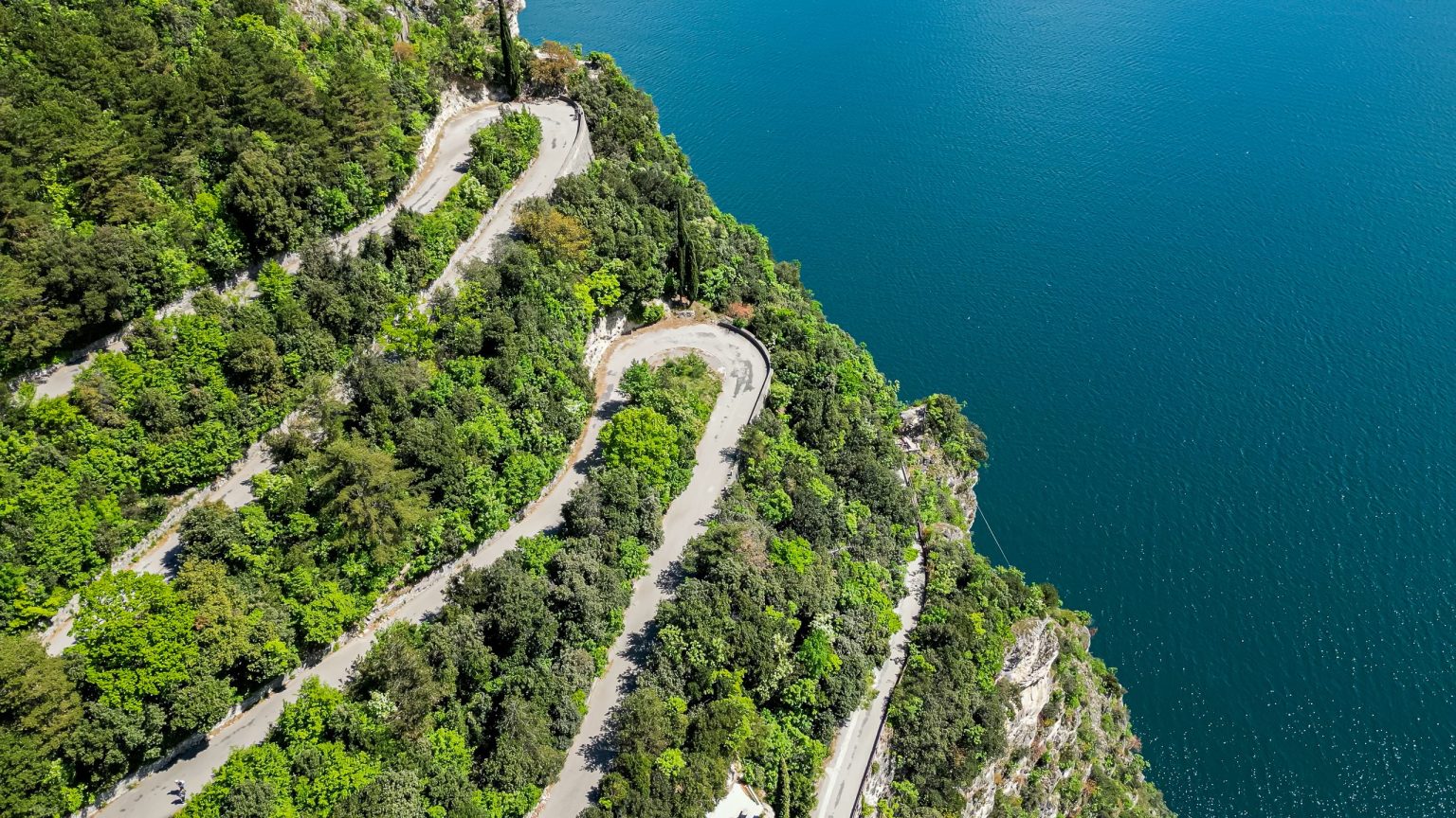Aerial view of hairpins on a cliff road above Lake Garda