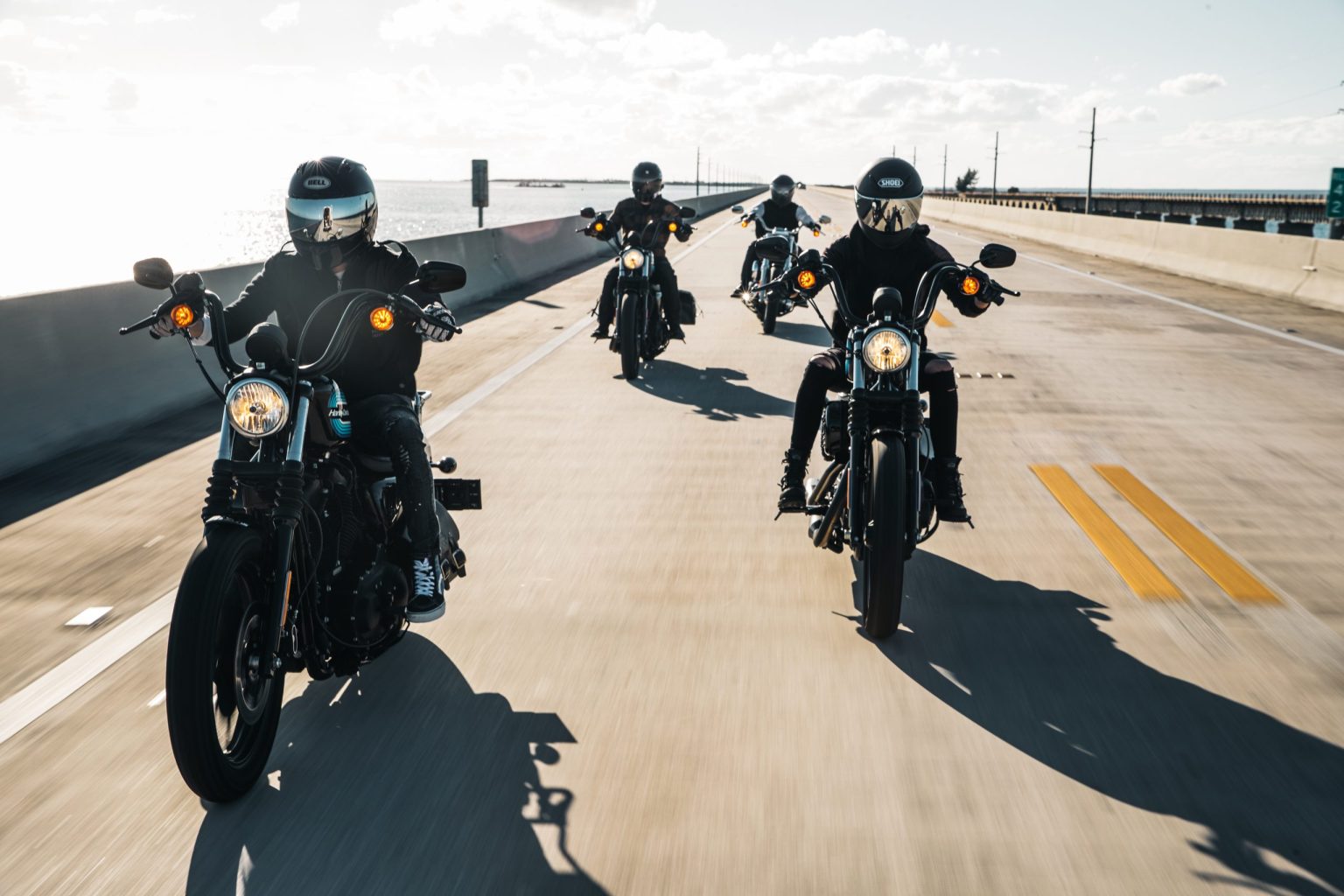 Group of motorcyclists riding across a Florida causeway bridge