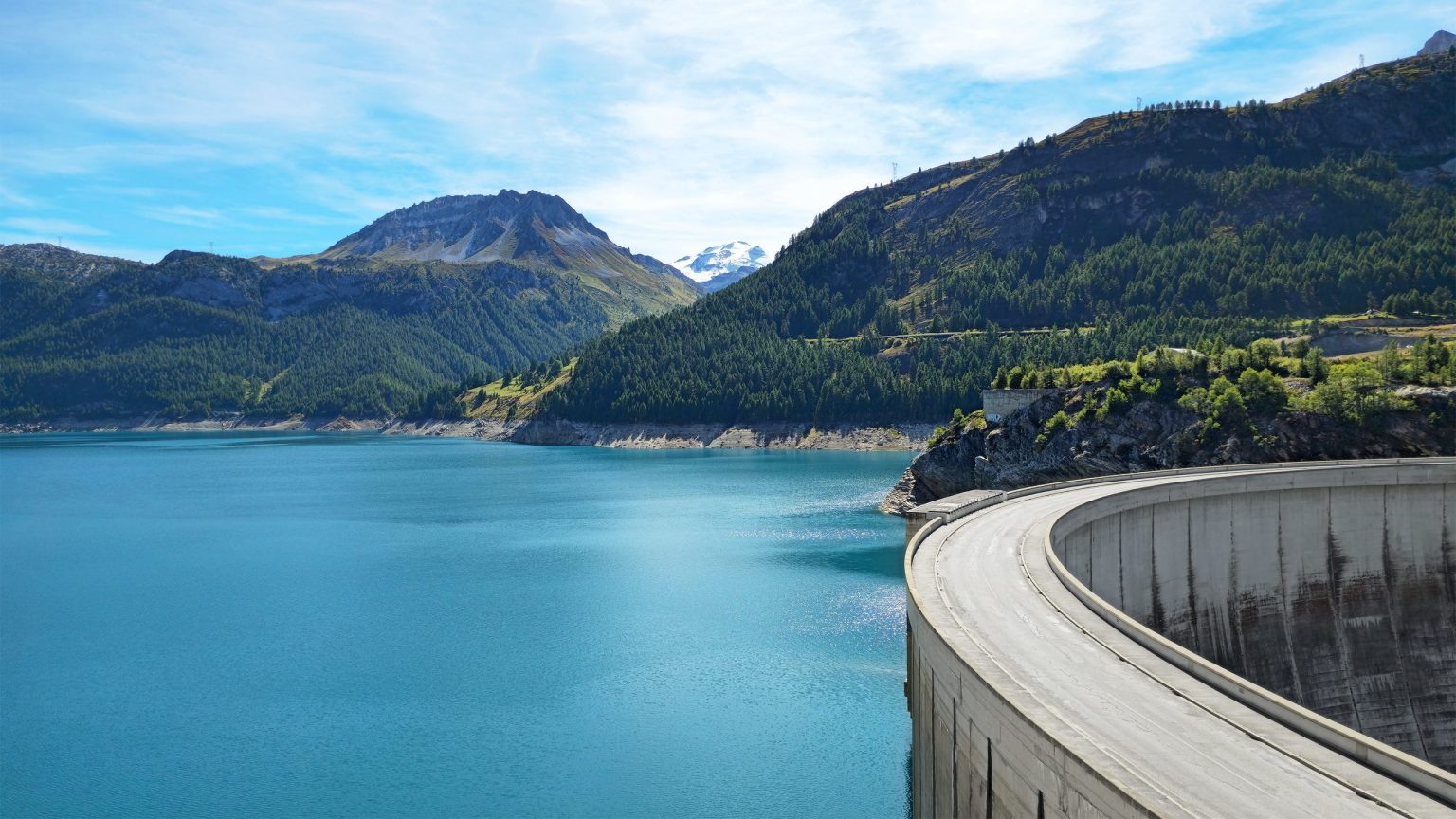 Road across a dam above a mountain reservoir in the French Alps