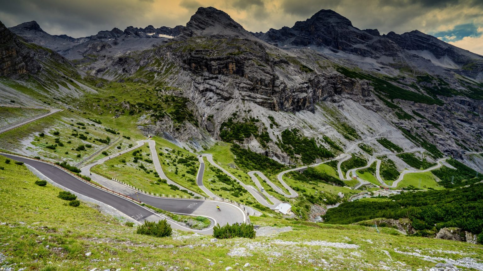 Stelvio Pass switchbacks under a stormy sky, Italian Alps