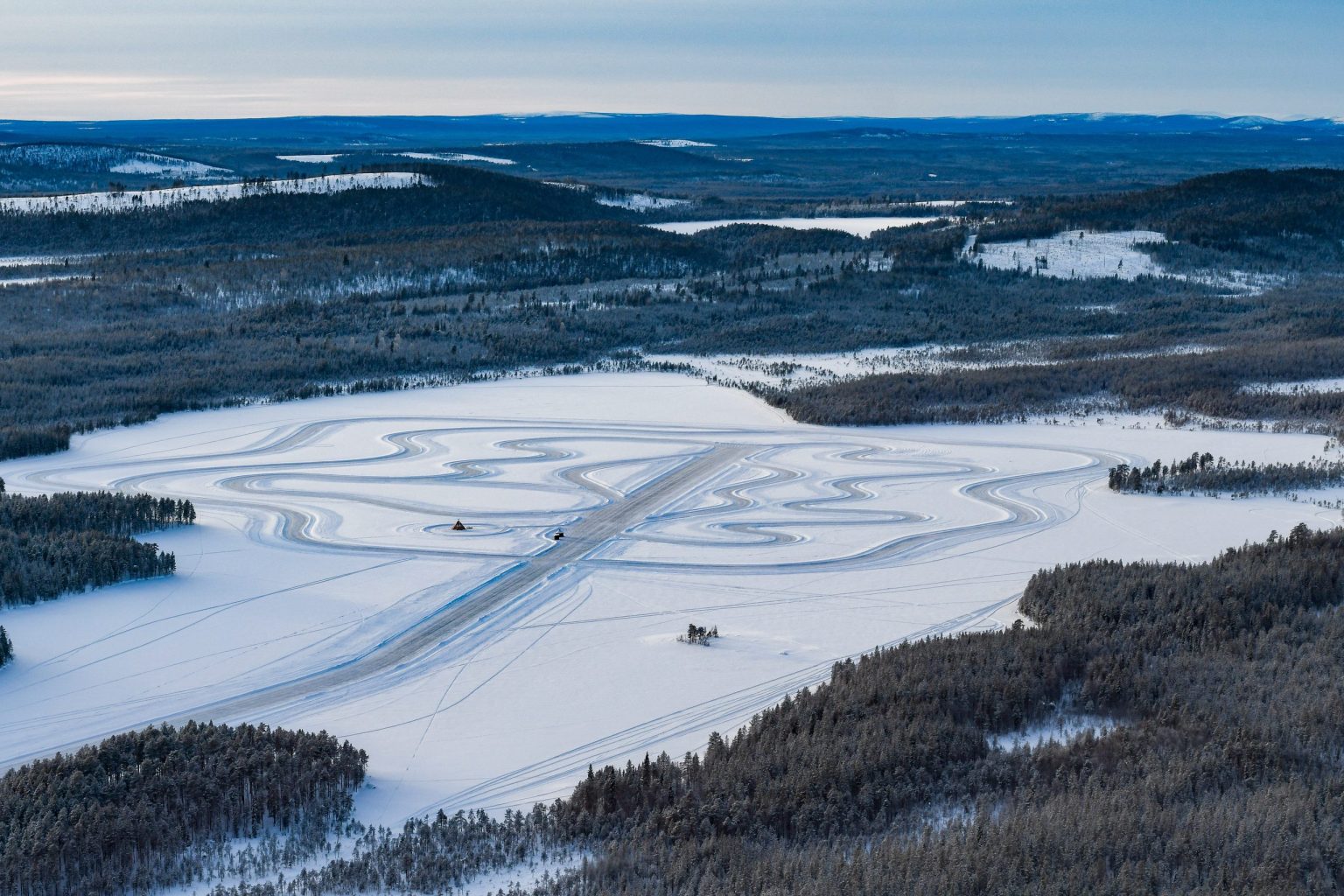 An ice driving track cut into a frozen lake, Lapland