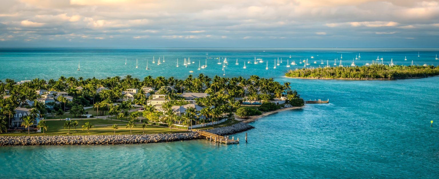 Aerial view of a palm-covered island in the turquoise water of the Florida Keys