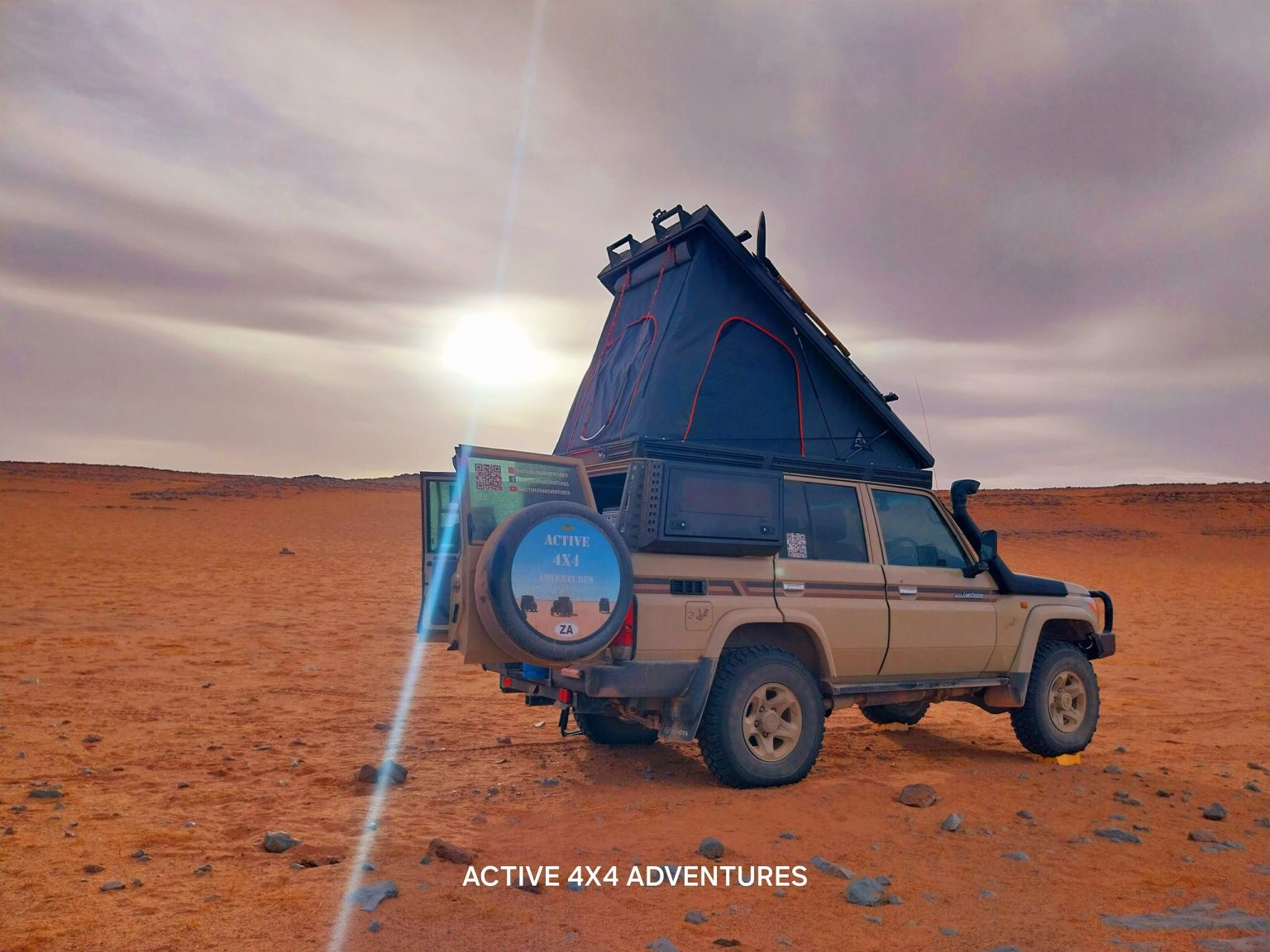 4x4 with a rooftop tent on the red plains of Morocco