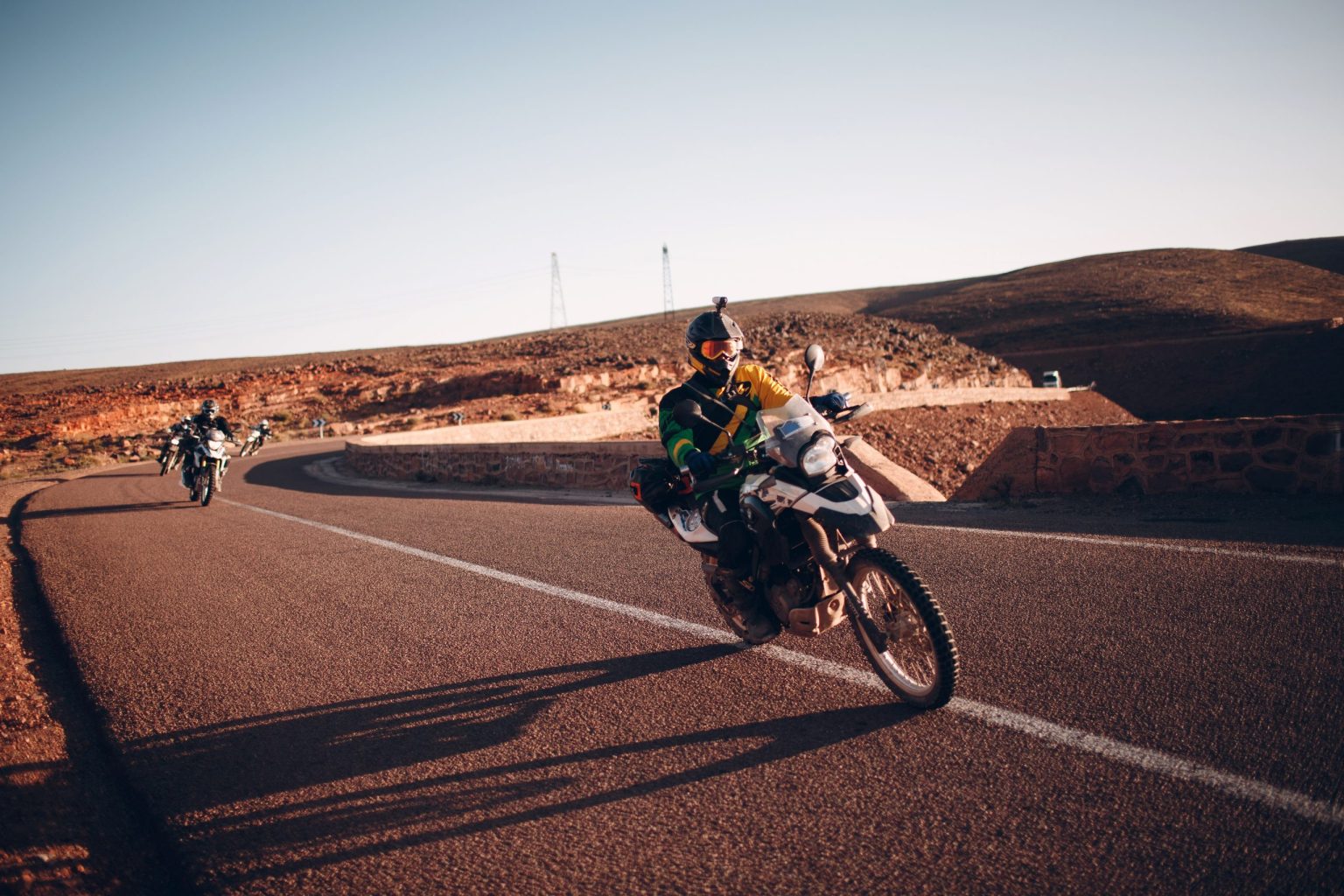 Adventure motorcyclists riding a desert road