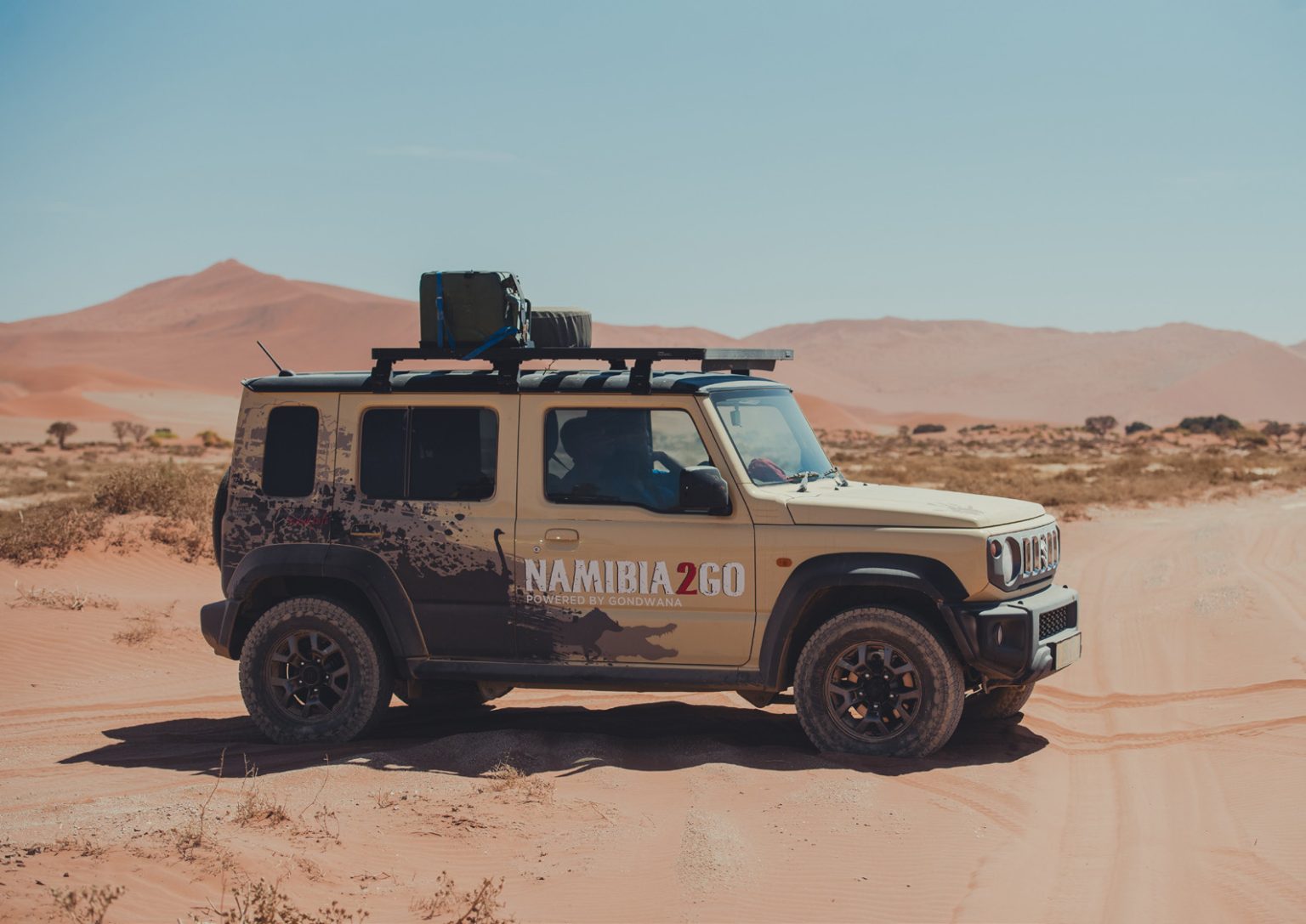 Suzuki Jimny expedition vehicle in the red dunes of Namibia