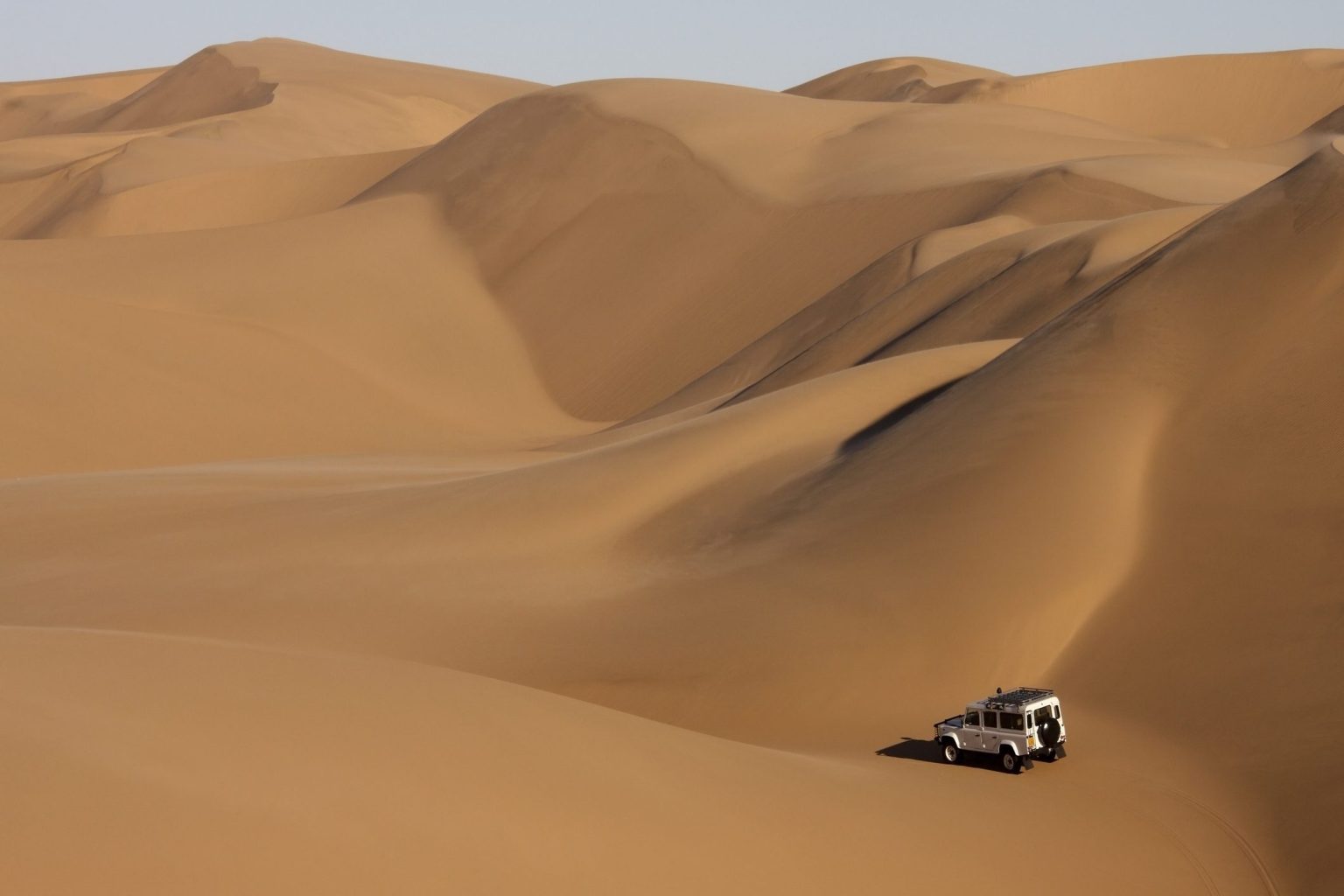 Land Rover Defender among Namib sand dunes