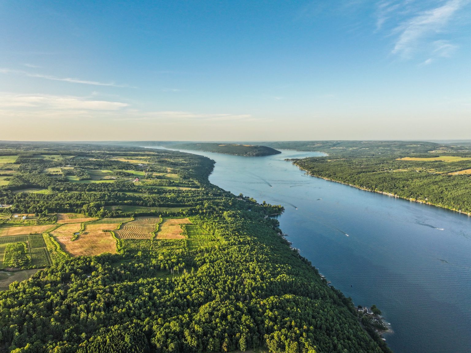 Aerial view of one of the Finger Lakes between farmland and forest, New York