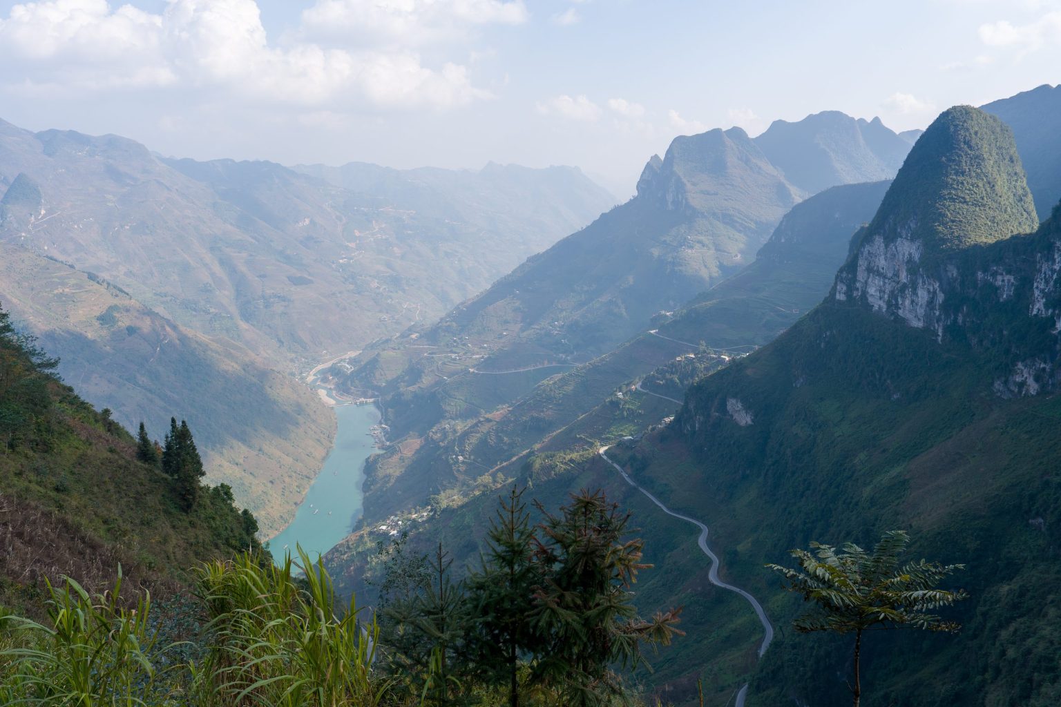 A mountain valley above a teal river in northern Vietnam