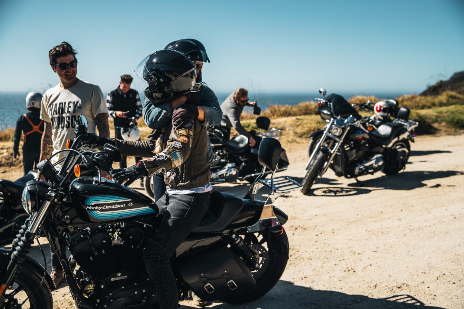 Riders gathered with their motorcycles at a Pacific Coast viewpoint