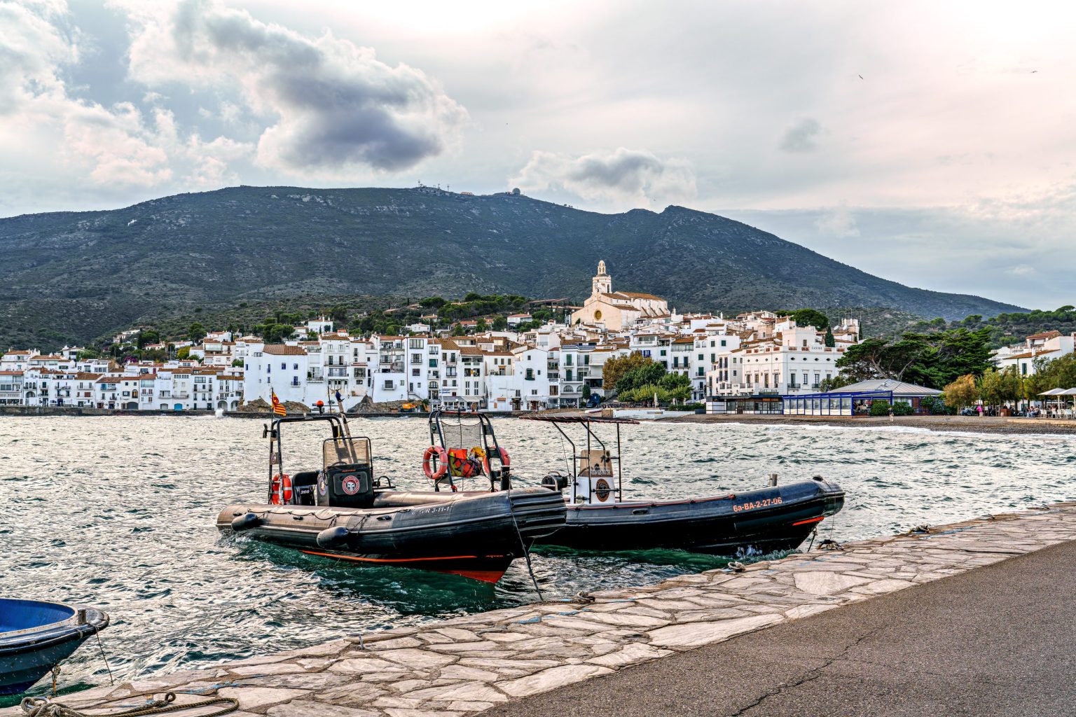 Boats moored in front of whitewashed Cadaques, Costa Brava