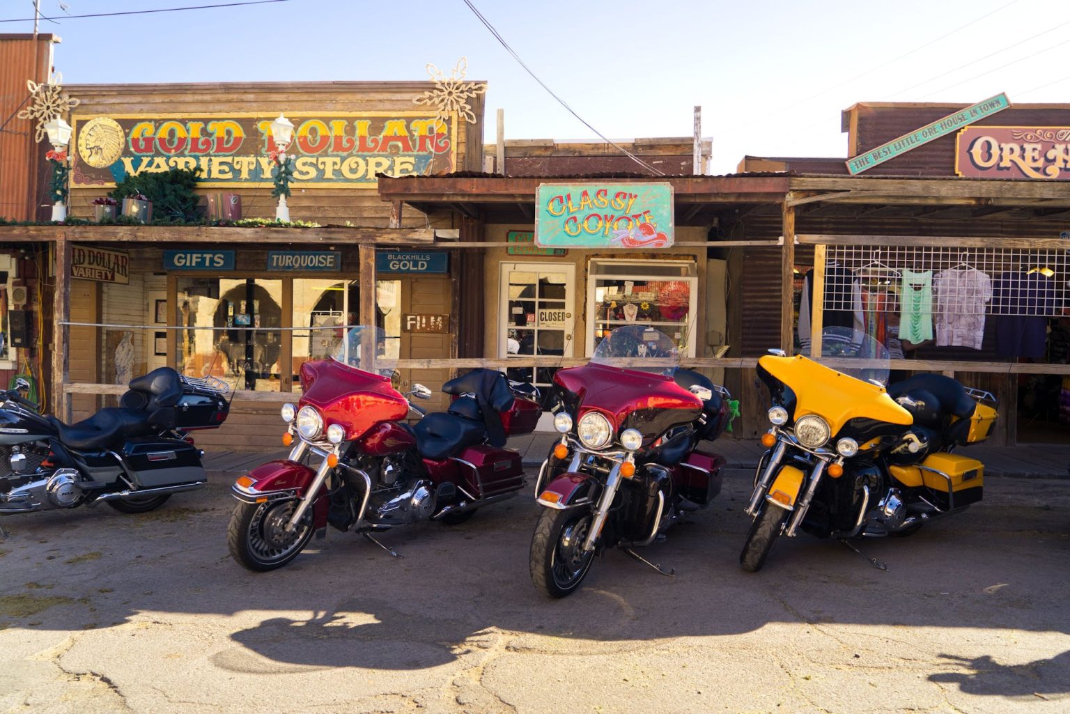 Harley-Davidsons parked outside souvenir shops on Route 66