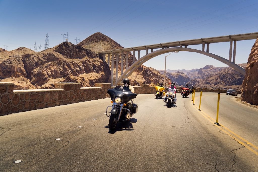 Riders passing under the Hoover Dam bypass bridge