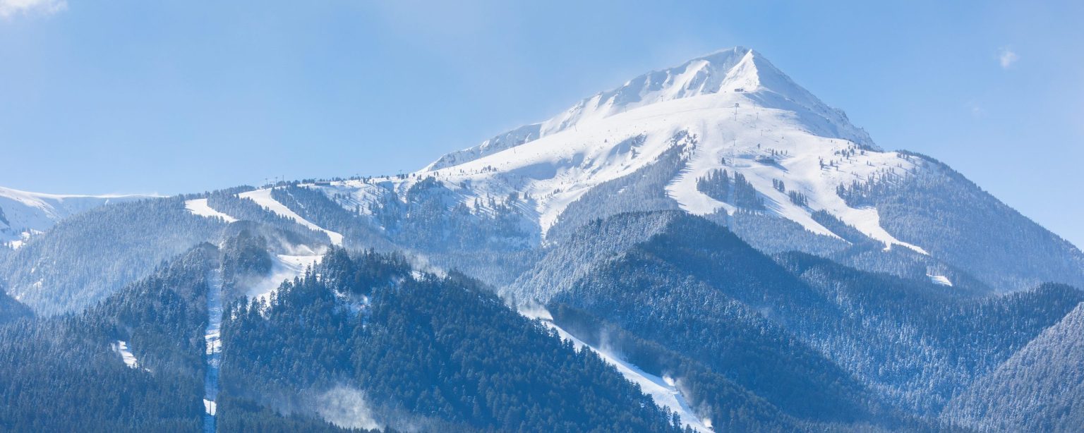 Snow-capped mountain above ski runs in the Pirin range