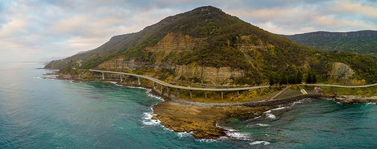 Long coastal road bridge along a steep headland beside the sea, New South Wales