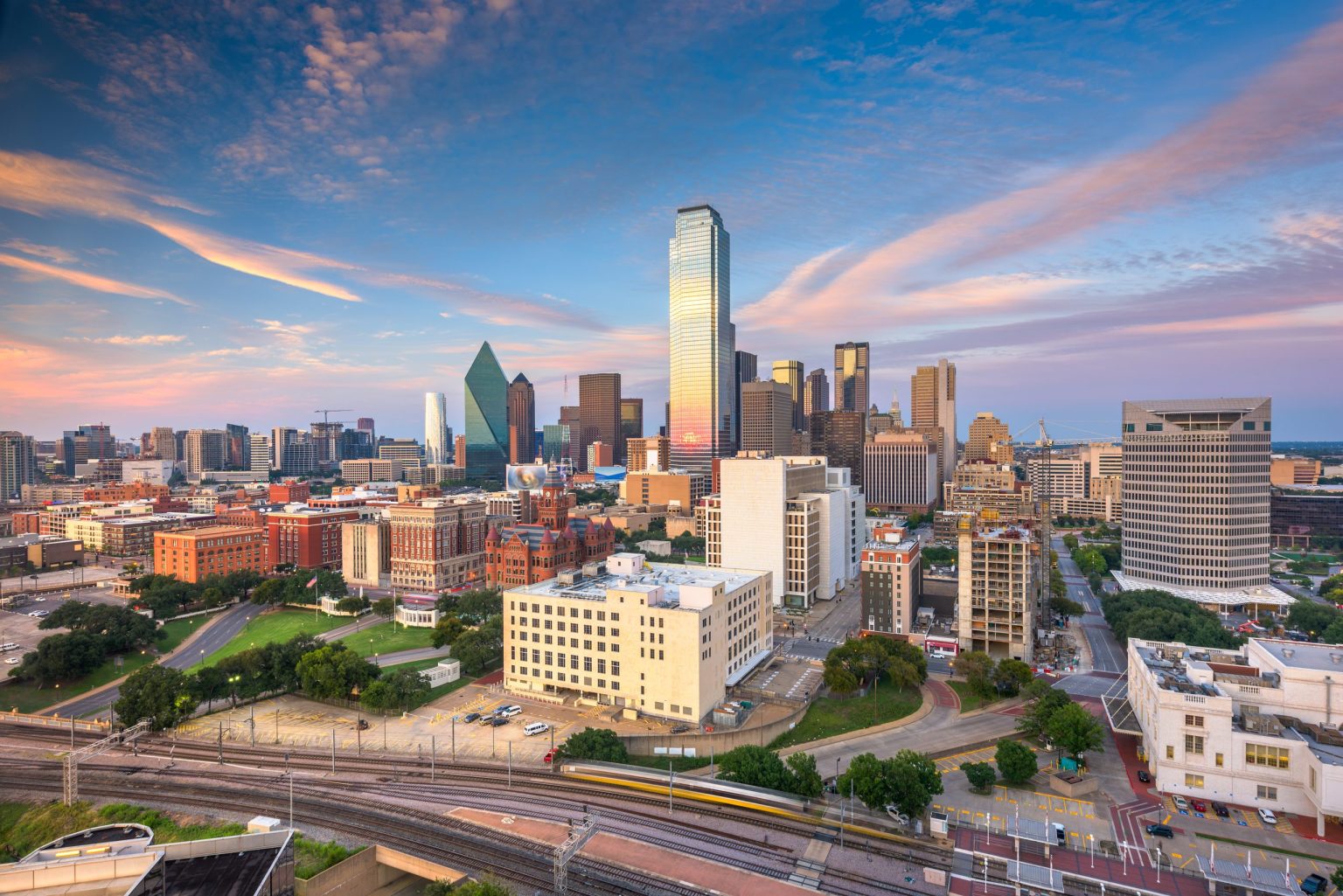 Downtown Dallas skyline under a pink evening sky
