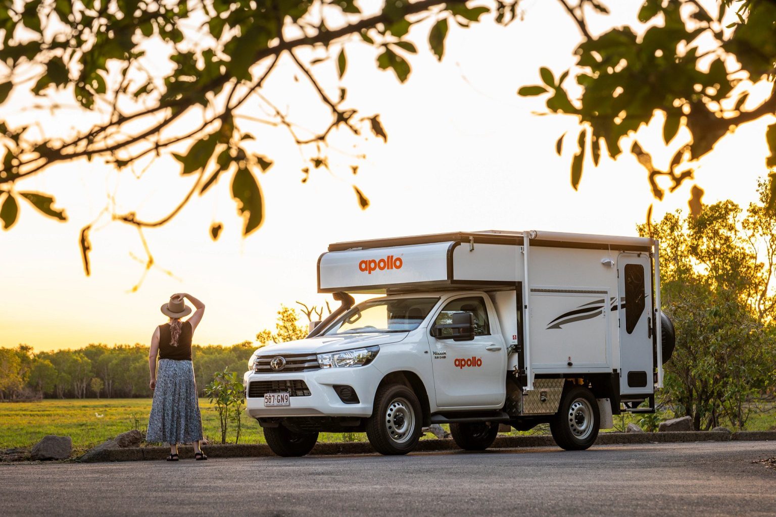 Woman beside a pickup camper at golden hour, Kakadu National Park, the Northern Territory