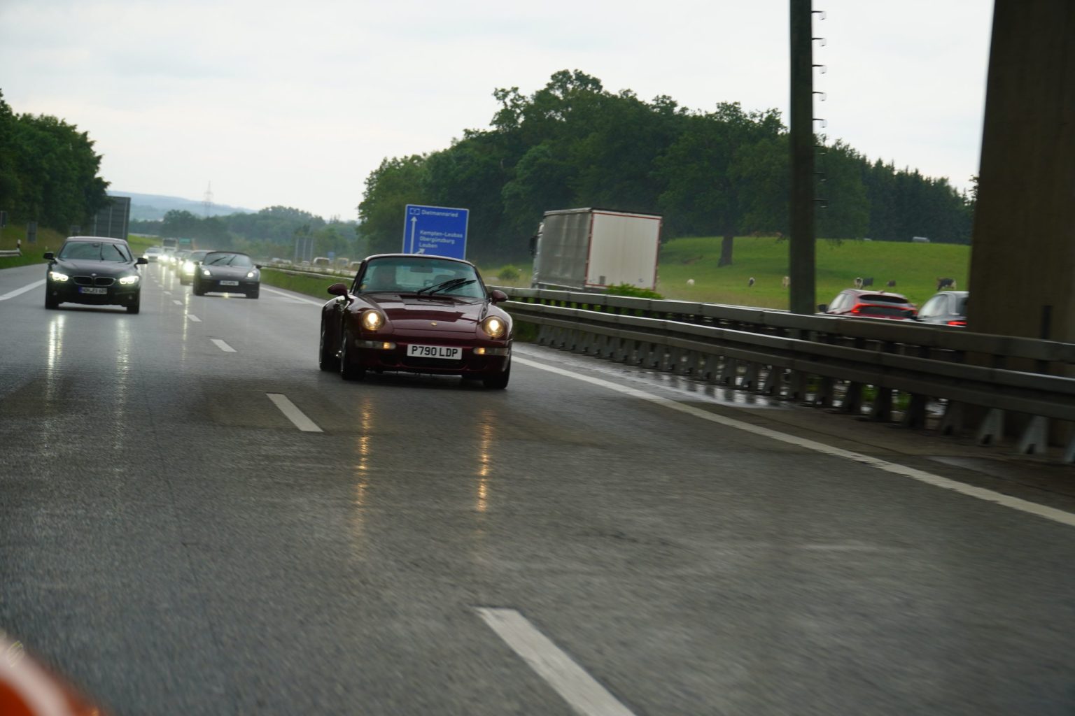 Porsche 911 on a wet Alpine pass road in Switzerland
