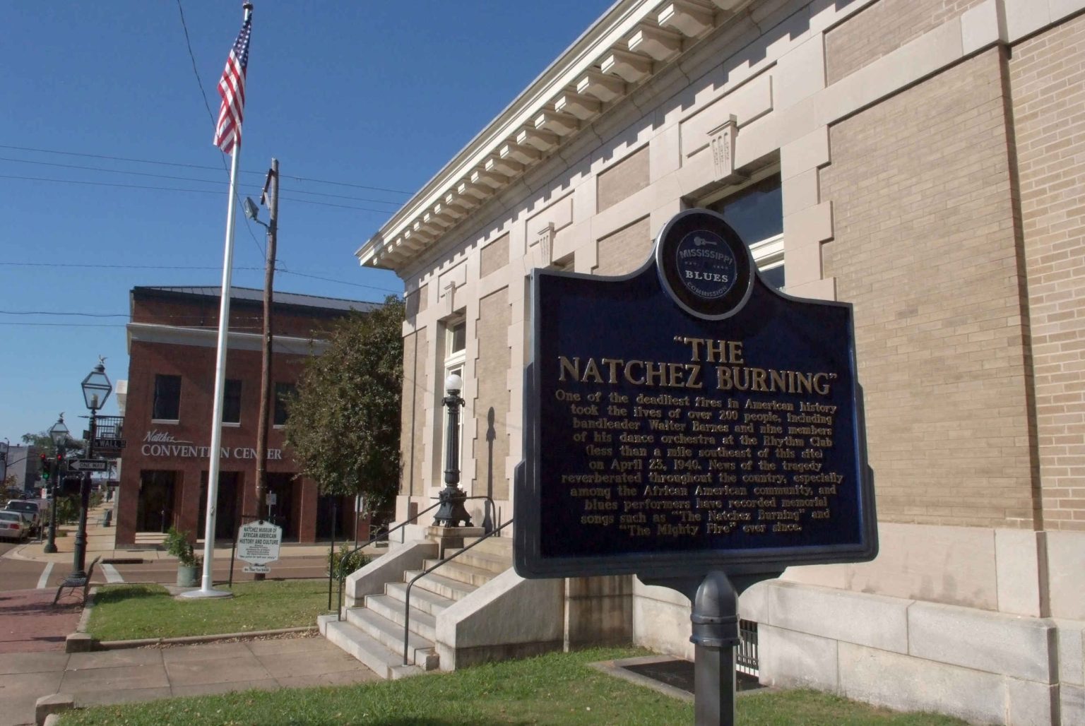 Historic marker for the Natchez Burning outside a stone building in Natchez, Mississippi