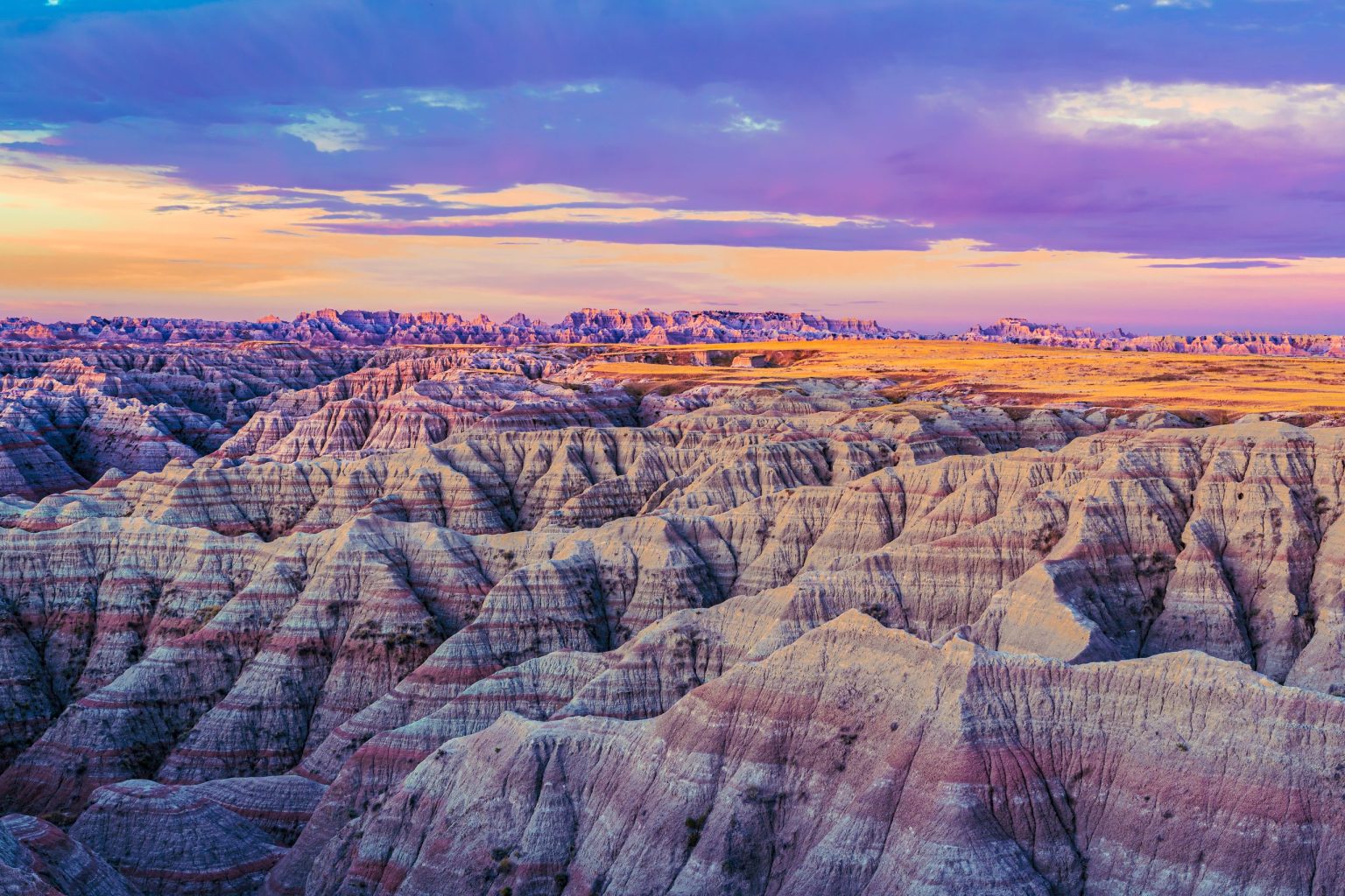 Eroded rock formations of Badlands National Park at sunset