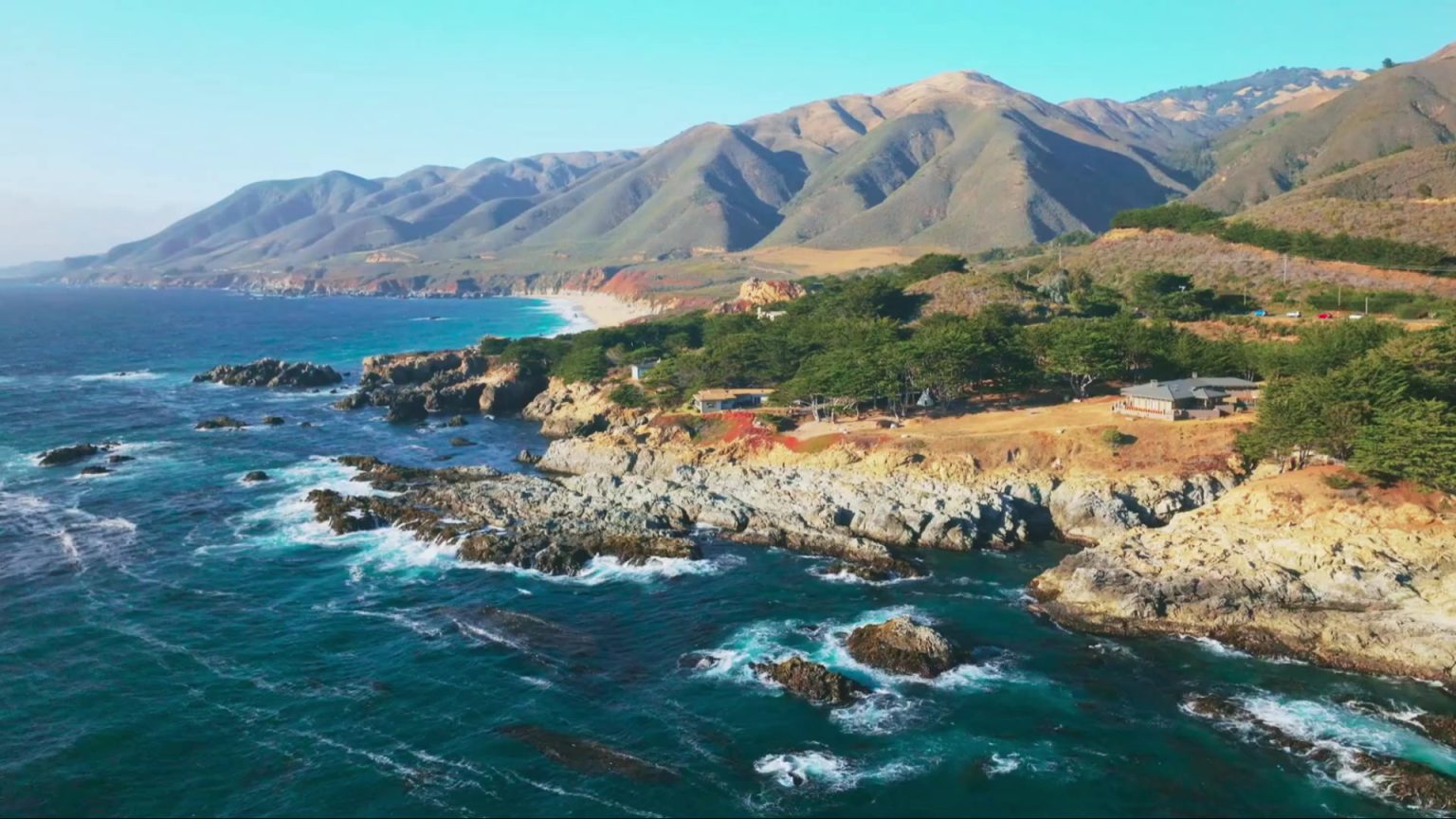Rugged Pacific coastline and green hills in central Chile